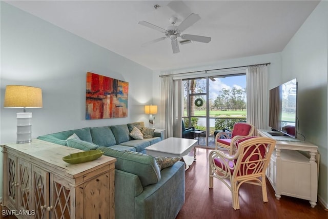 living room featuring dark wood-style flooring and ceiling fan