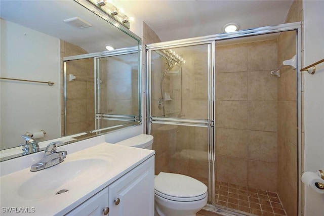 bathroom featuring toilet, vanity, and an enclosed shower