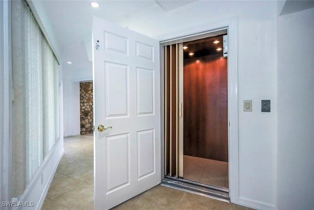 hallway with light tile patterned floors