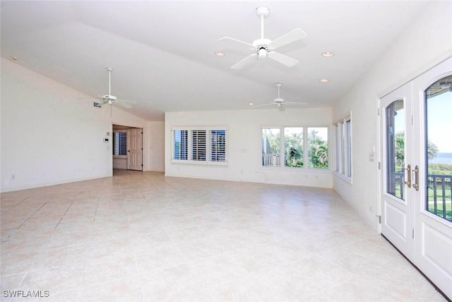 spare room featuring french doors, lofted ceiling, ceiling fan, and light tile patterned floors