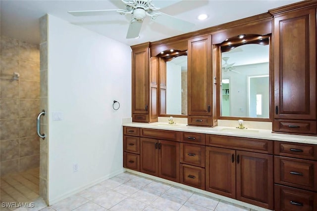 bathroom featuring vanity, ceiling fan, tile patterned flooring, and tiled shower