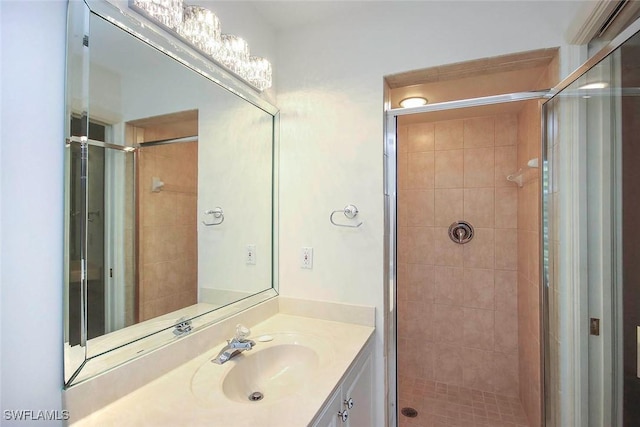 bathroom featuring vanity and a shower with shower door