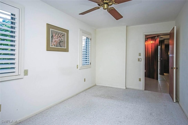 carpeted empty room with ceiling fan