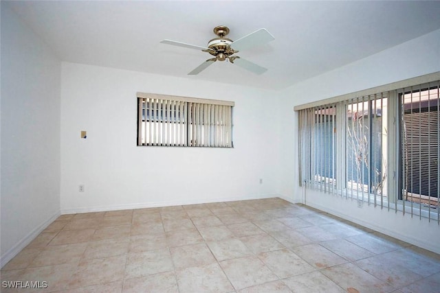 spare room with light tile patterned floors and ceiling fan