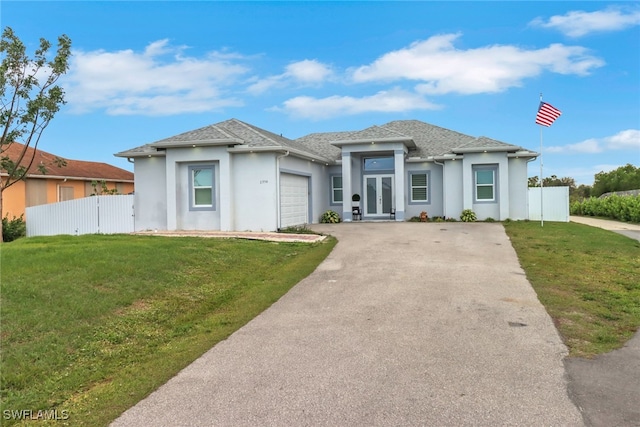 view of front of house featuring a garage and a front lawn