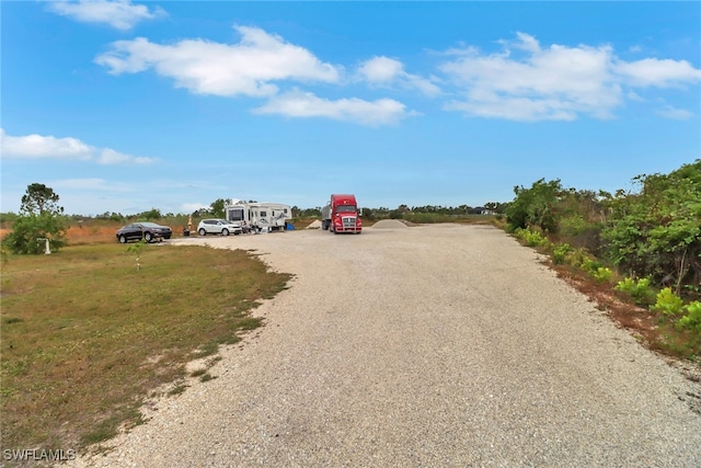 view of road with gravel driveway