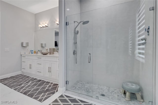 full bathroom with double vanity, a shower stall, and a sink