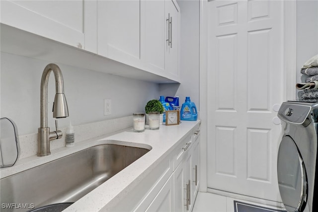 kitchen featuring white cabinetry, light countertops, and a sink