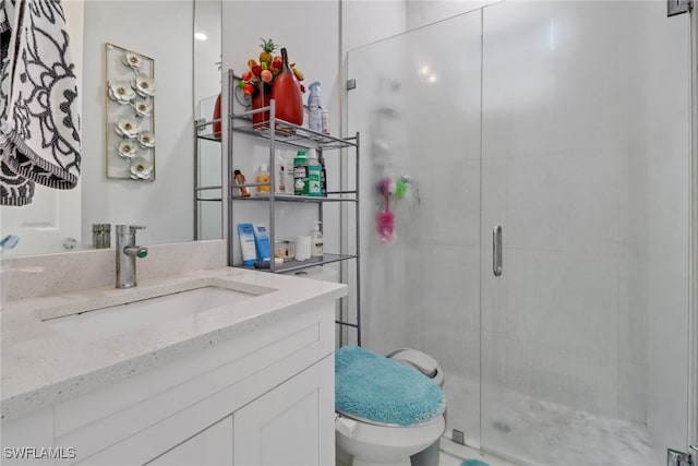 full bathroom with a stall shower, vanity, and toilet