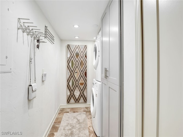 interior space with stone finish floor, stacked washer and dryer, baseboards, and recessed lighting