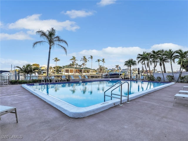 pool with fence and a patio