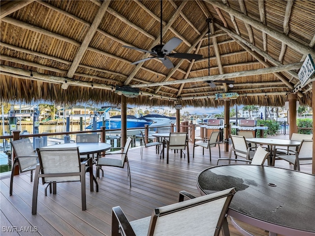 wooden deck with a water view and a gazebo