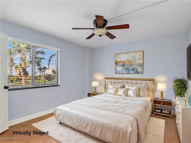 bedroom featuring a ceiling fan and baseboards