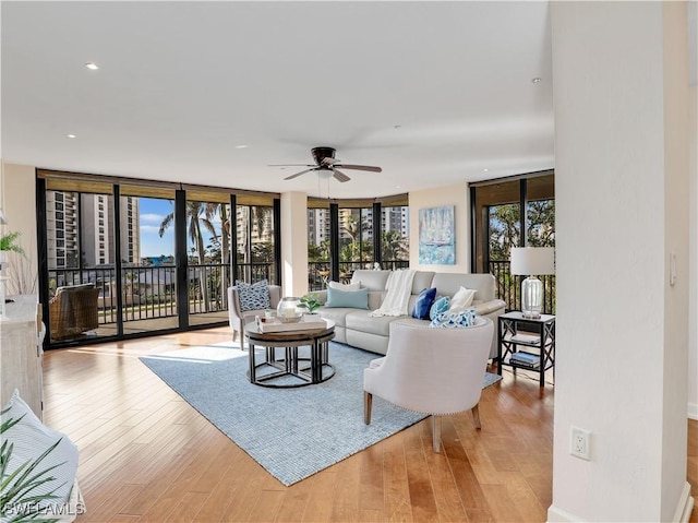 living room with light wood-style floors, a wealth of natural light, and floor to ceiling windows