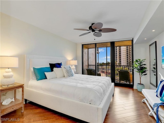 bedroom with recessed lighting, a ceiling fan, expansive windows, wood finished floors, and access to outside