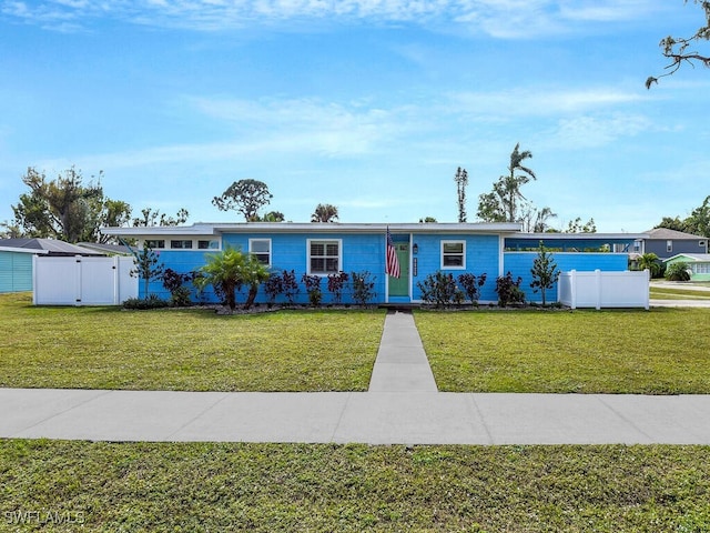 view of front of home with a gate, fence, and a front yard