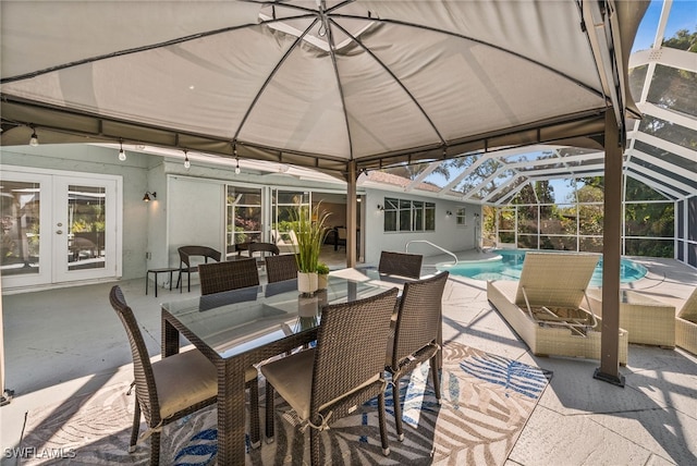 view of patio with french doors, outdoor lounge area, and a lanai