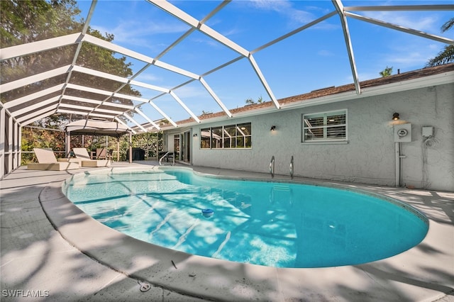 view of pool with a lanai and a patio area