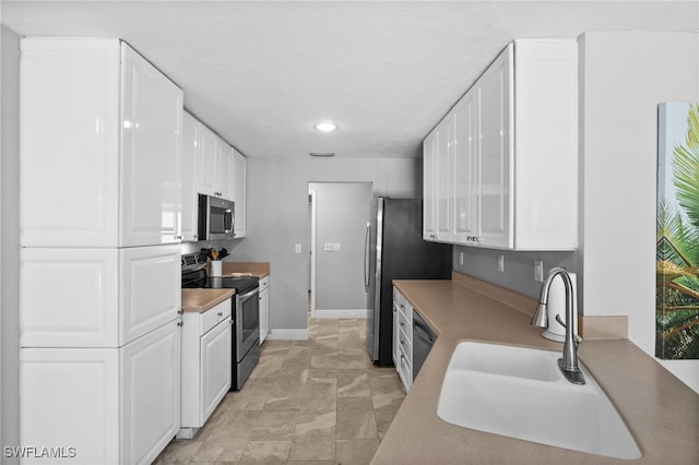 kitchen with white cabinetry, sink, and appliances with stainless steel finishes