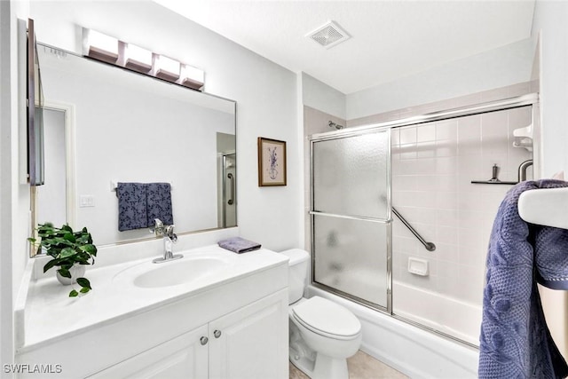 bathroom featuring visible vents, toilet, vanity, and combined bath / shower with glass door