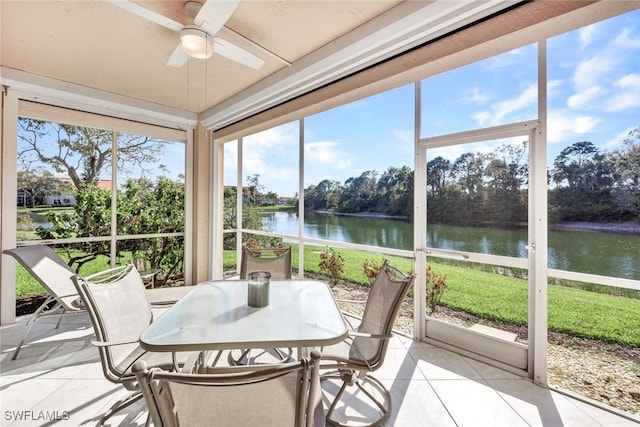 sunroom / solarium with a water view and a ceiling fan