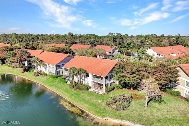 birds eye view of property with a water view