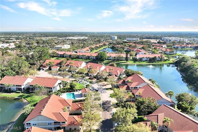 drone / aerial view featuring a residential view and a water view