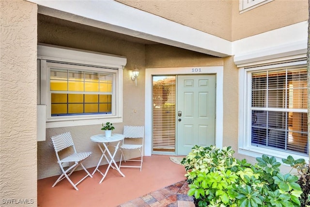 entrance to property with stucco siding