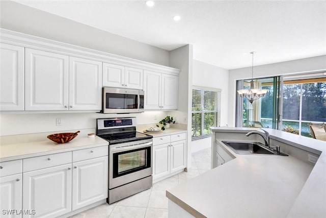 kitchen featuring light tile patterned floors, white cabinets, stainless steel appliances, light countertops, and a sink