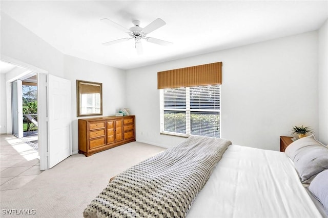 bedroom with access to exterior, carpet, multiple windows, and ceiling fan