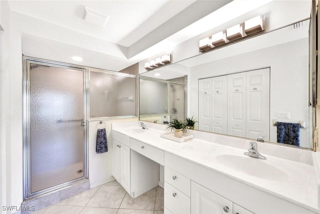 full bathroom with a stall shower, tile patterned floors, a sink, and double vanity