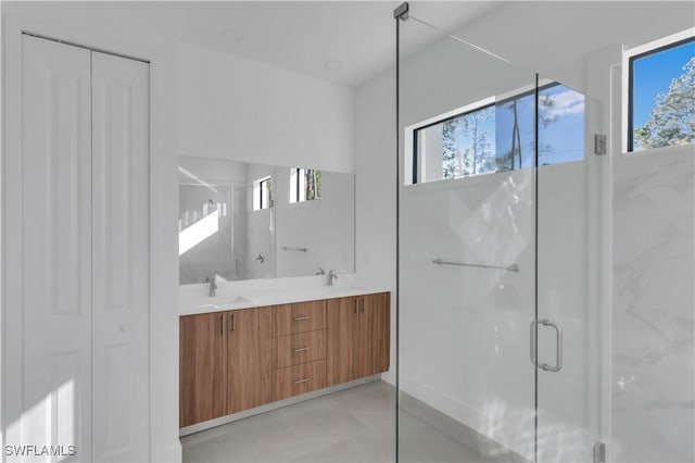 bathroom with vanity and a shower with shower door