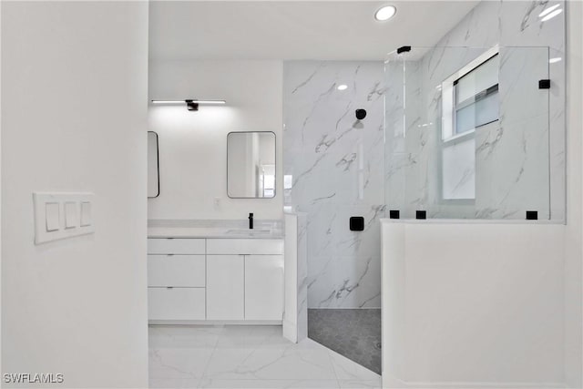 bathroom featuring a tile shower and vanity