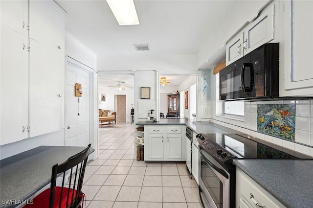 kitchen with range with electric cooktop, tasteful backsplash, white cabinets, light tile patterned floors, and ceiling fan