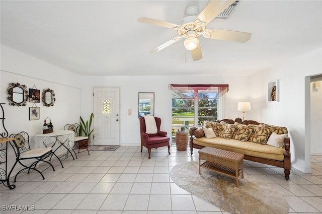 tiled living room featuring ceiling fan