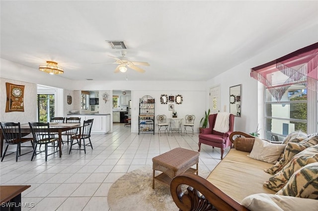 tiled living room featuring ceiling fan