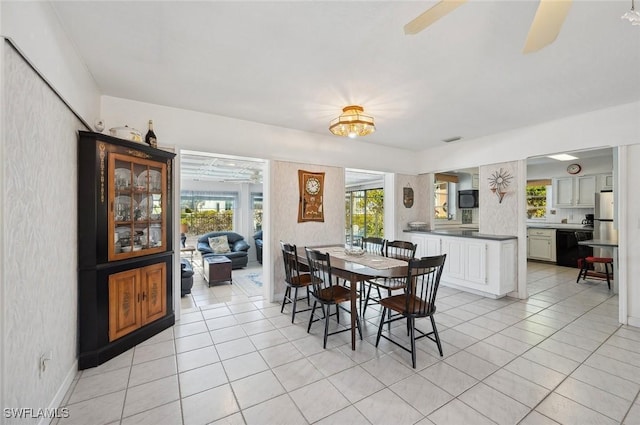 tiled dining area featuring ceiling fan