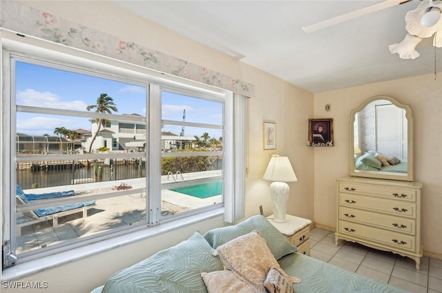 living area with light tile patterned floors and a water view