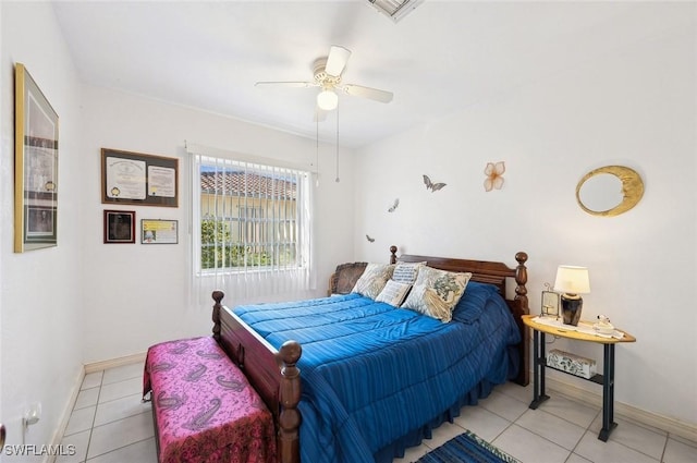 tiled bedroom featuring ceiling fan