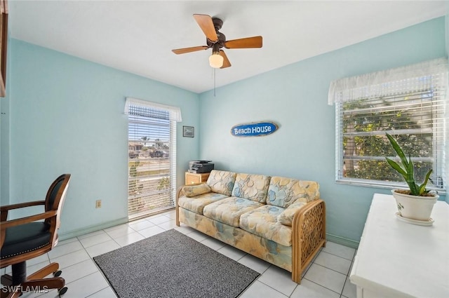 tiled home office featuring ceiling fan