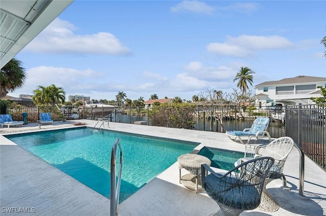 view of pool with a patio and a water view