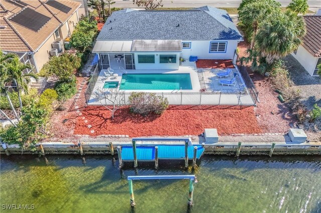 rear view of house featuring a fenced in pool and a patio