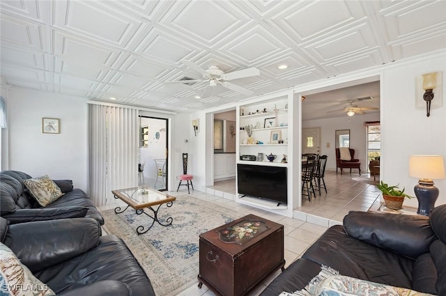 tiled living room featuring built in features and ceiling fan