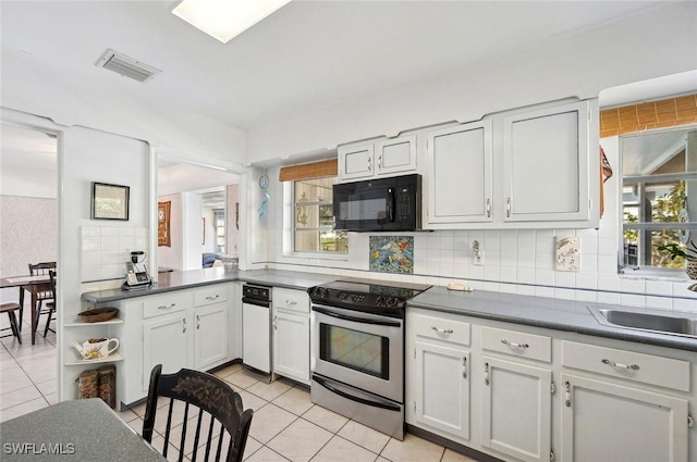 kitchen featuring light tile patterned flooring, sink, white cabinetry, tasteful backsplash, and stainless steel electric range