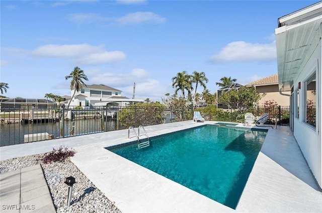 view of pool with a water view and a patio