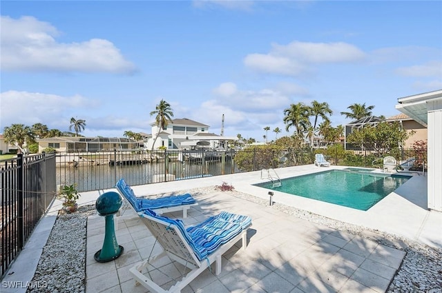 view of pool with a patio area and a water view