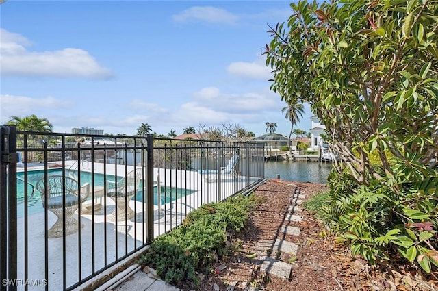 view of swimming pool with a water view and a patio area