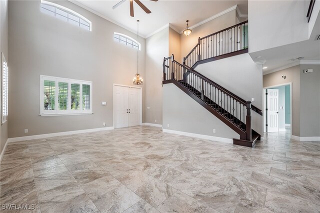 2534 Verdmont Ct, Cape Coral, FL 33991 - unfurnished living room featuring baseboards, stairway, a wealth of natural light, and ceiling fan with notable chandelier