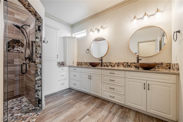 2534 Verdmont Ct, Cape Coral, FL 33991 - full bath featuring crown molding, double vanity, a stall shower, a sink, and wood finished floors