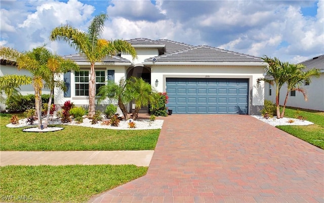 view of front of property featuring a garage and a front lawn